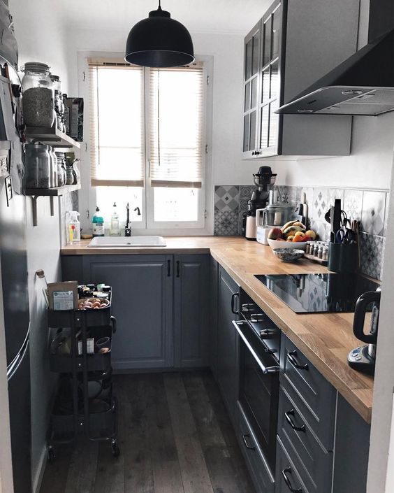 https://www.digsdigs.com/photos/2012/02/a-graphite-grey-kitchen-with-butcherblock-countertops-a-black-cart-and-a-black-pendant-lamp-and-grey-printed-tiles.jpg