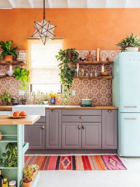 https://www.digsdigs.com/photos/2012/03/a-bold-kitchen-with-grey-cabinets-an-orange-printed-tile-backsplash-a-mint-blue-fridge-and-a-kitchen-island-plus-a-colorful-rug.jpg