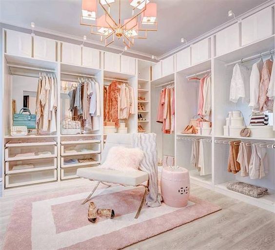 https://www.digsdigs.com/photos/2013/04/a-glam-feminine-closet-with-open-storage-units-drawers-a-pink-chandelier-a-chair-and-a-side-table-plus-a-pink-printed-rug.jpg