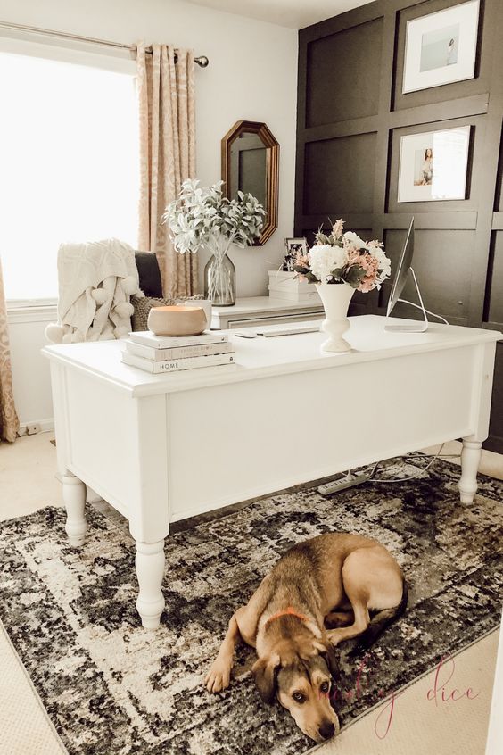 https://www.digsdigs.com/photos/2013/04/an-elegant-feminine-home-office-with-a-black-paneled-wall-a-white-vintage-desk-printed-curtains-and-a-rug-and-some-blooms.jpg