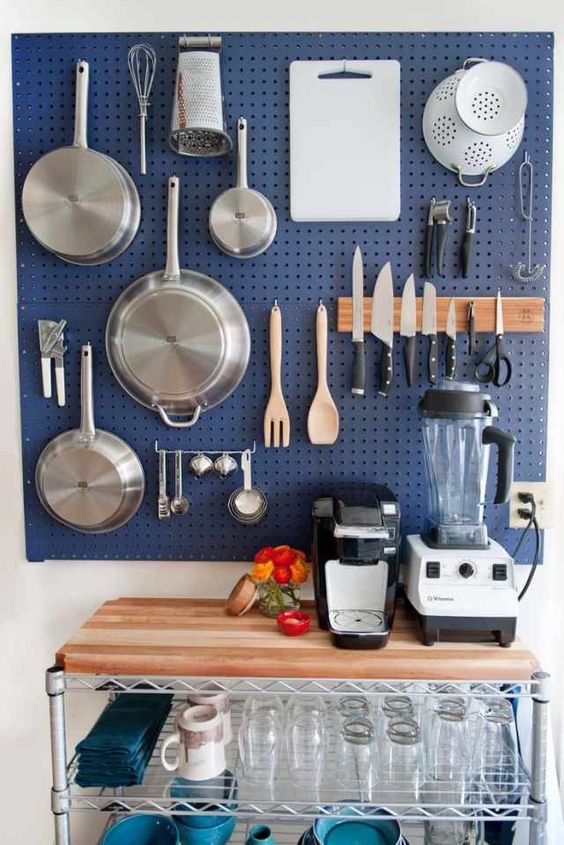https://www.digsdigs.com/photos/2013/08/a-large-blue-pegboard-with-hooks-and-hangers-holding-various-pans-pots-and-other-stuff-is-a-great-solution-for-a-kitchen.jpg