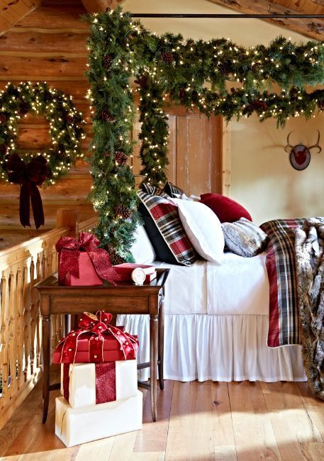 A Christmas Bedroom With Evergreens Lights Pinecones And Large Gift Boxes That Will Make You Feel Very Holiday Like 
