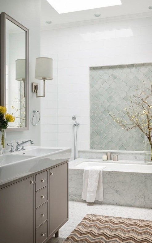 https://www.digsdigs.com/photos/2013/11/a-beautiful-serene-bathroom-with-a-skylight-a-neutral-vanity-a-bathtub-clad-with-stone-mint-green-arabesque-tiles-for-an-accent.jpg