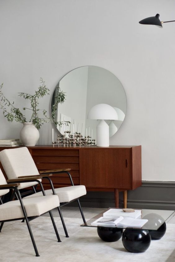 a beautiful dark-stained sideboard with doors and carved out handles and cone legs is a lovely idea for a modern living room