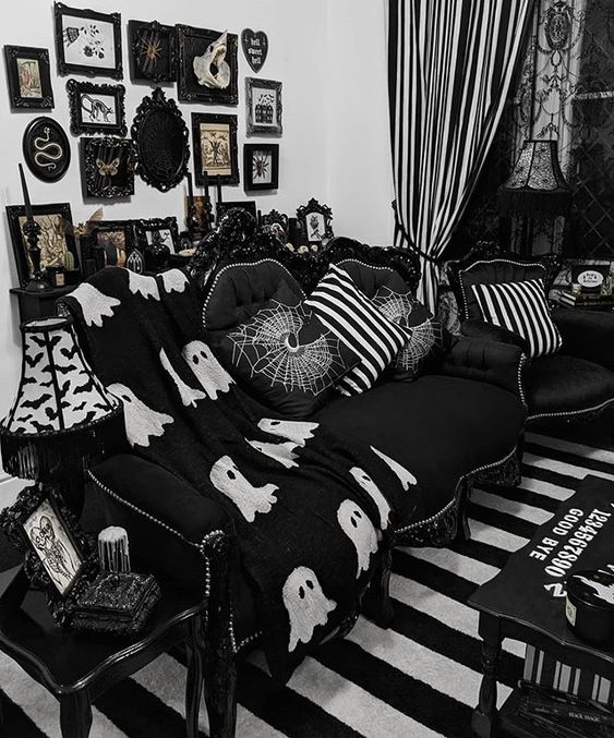 https://www.digsdigs.com/photos/2014/02/a-fun-Gothic-living-room-done-in-black-and-white-with-refined-furniture-printed-pillows-a-catchy-gallery-wall-and-textiles.jpg