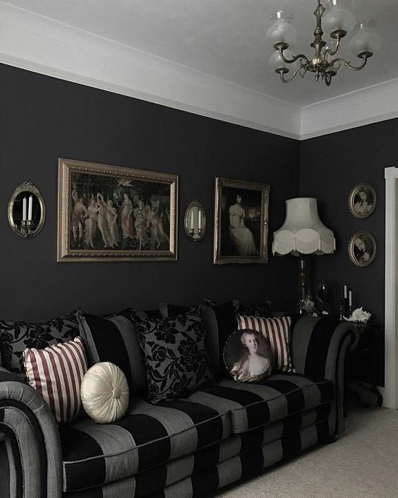 https://www.digsdigs.com/photos/2014/02/a-stylish-Gothic-living-room-with-black-walls-a-striped-sofa-artworks-a-chandelier-and-printed-pillows.jpg