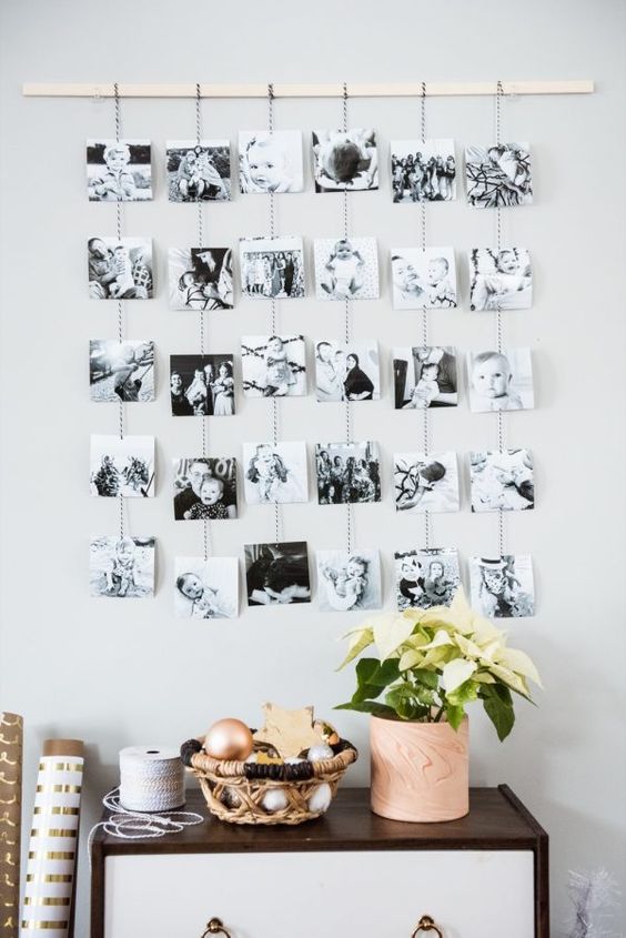 https://www.digsdigs.com/photos/2015/02/a-photo-display-with-a-wooden-rail-and-black-and-white-photos-on-yarn-hanging-down-is-a-lovely-idea.jpg