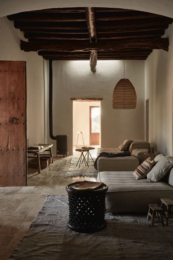 A Chic Wabi Sabi Interior With White Walls A Pendant Lamp A Tile Floor And A Hearth 