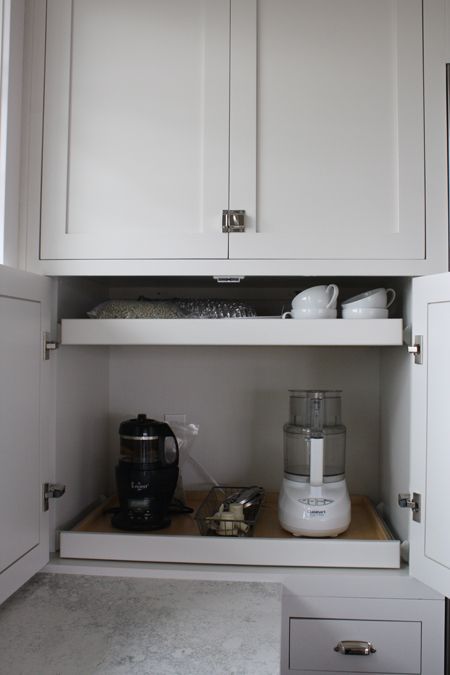 https://www.digsdigs.com/photos/2015/05/a-small-cabinet-with-retractable-shelves-that-hold-appliances-and-mugs-is-a-cool-idea-to-make-your-own-tea-and-coffee-station-hidden.jpg