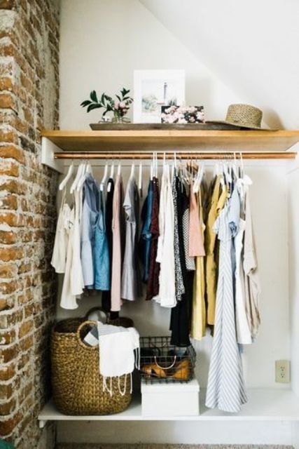 https://www.digsdigs.com/photos/2015/09/an-open-closet-in-the-corner-with-a-holder-for-hangers-and-an-open-shelf-plus-baskets-is-a-cool-way-to-use-a-small-nook.jpg