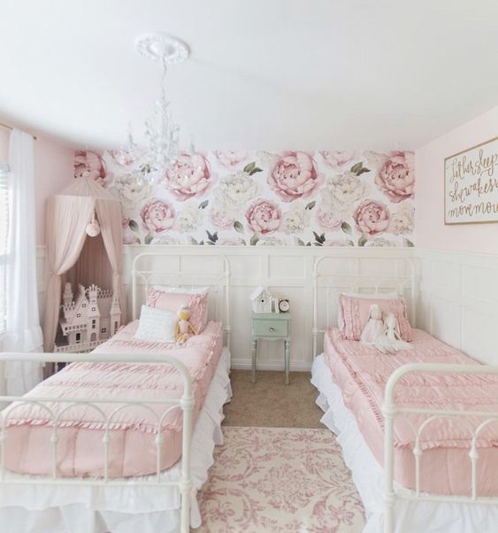 https://www.digsdigs.com/photos/2016/04/a-sophisticated-shared-girls-bedroom-with-white-metal-beds-pink-and-white-bedding-white-paneled-walls-a-pink-canopy-over-a-doll-house.jpg