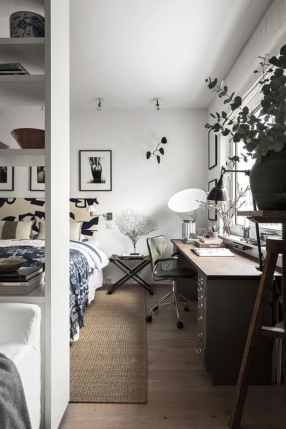 https://www.digsdigs.com/photos/2016/07/a-Scandinavian-bedroom-with-a-large-bed-and-printed-bedding-a-large-desk-a-black-chair-a-nightstand-and-cool-artwork.jpg