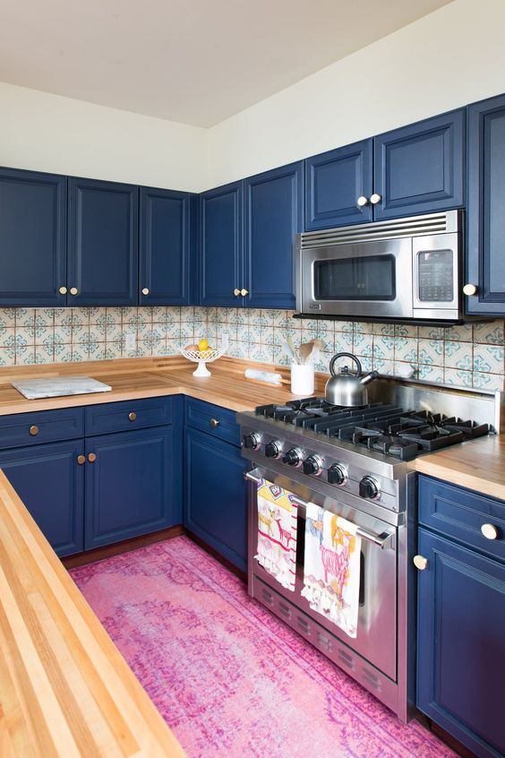 https://www.digsdigs.com/photos/2017/08/06-a-bold-blue-kitchen-with-light-colored-wooden-countertops-and-a-mosaic-tile-backsplash.jpg