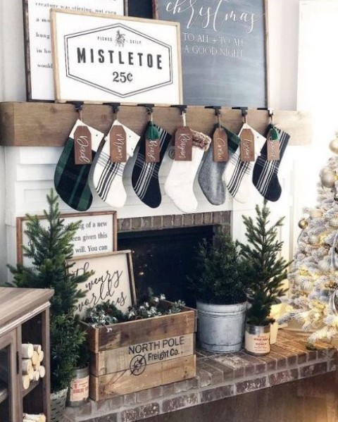 https://www.digsdigs.com/photos/2017/12/a-farmhouse-living-room-with-plaid-stockings-a-crate-with-evergreens-mini-Christmas-trees-and-a-neutral-Christmas-tree.jpg