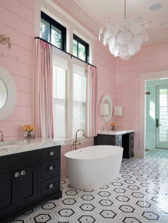 https://www.digsdigs.com/photos/2018/05/a-delightful-bathroom-with-pink-slatted-walls-black-vanities-an-oval-tub-a-geo-tiled-floor-and-a-scale-chandelier.jpg