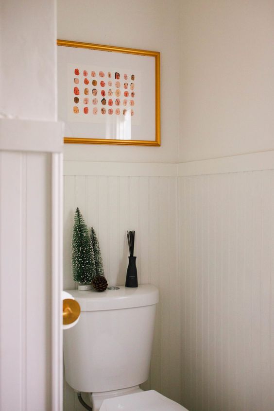 some tinsel Christmas tree on the toilet and a single pinecone - you won't need more to create a cool holiday feel