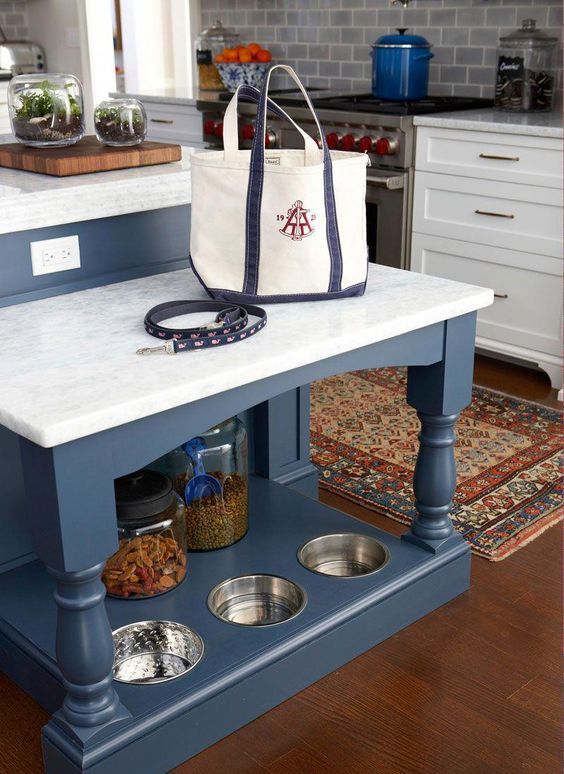 https://www.digsdigs.com/photos/2019/01/22-a-kitchen-island-with-an-additional-table-and-a-dog-feeding-station-in-its-lower-part.jpg