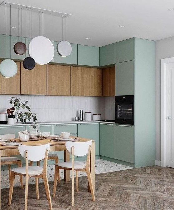 A Lovely Sage Green Kitchen With Stained Cabinets A Skinny Tile Backsplash A Very Eye Catchy Pendant Lamp Arrangement 
