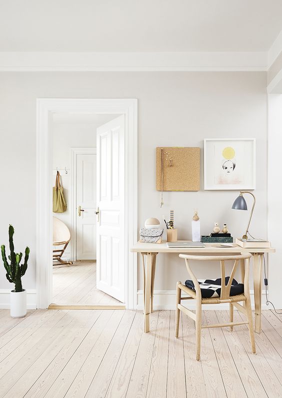 https://www.digsdigs.com/photos/2019/10/a-cozy-neutral-home-office-with-some-wooden-furniture-art-on-the-wall-and-a-cactus-in-a-pot.jpg