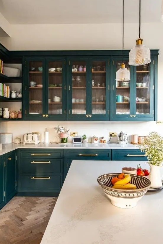 https://www.digsdigs.com/photos/2020/03/a-chic-and-refined-teal-kitchen-with-glass-and-shaker-cabinets-white-countertops-and-a-white-backsplash-plus-pendant-lamps.jpg