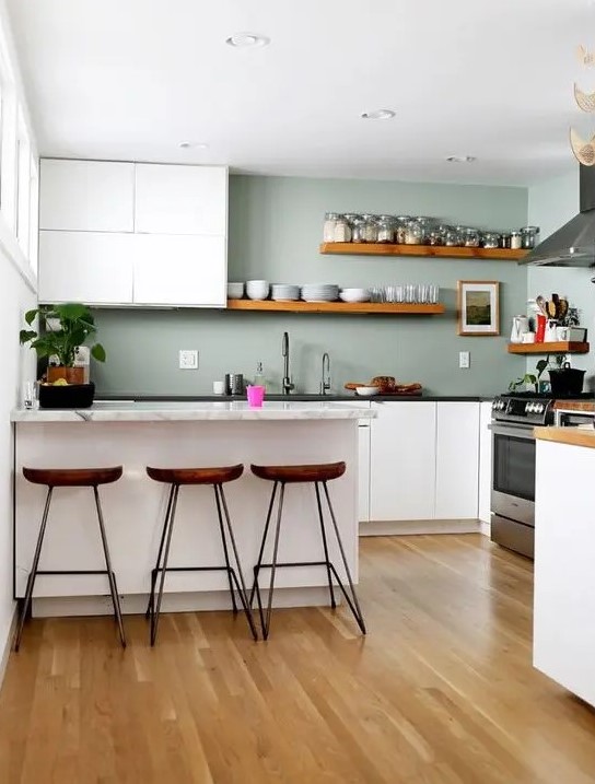 https://www.digsdigs.com/photos/2020/03/a-minimalist-kitchen-with-white-cabinets-sage-green-walls-stone-countertops-and-wooden-shelves-and-stools.jpg
