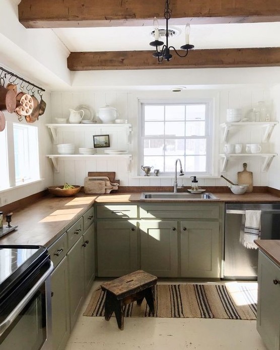 https://www.digsdigs.com/photos/2020/03/a-relaxed-farmhouse-kitchen-with-white-shiplap-walls-light-green-cabinets-butcherblock-countertops-wooden-beams.jpg