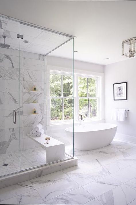 بالصور ديكورات حمامات انيقة باللون الابيض لمنزلك في ربيع 2020 حصري A-luxurious-white-bathroom-clad-with-white-marble-tiles-and-a-large-window-for-more-natural-light-inside