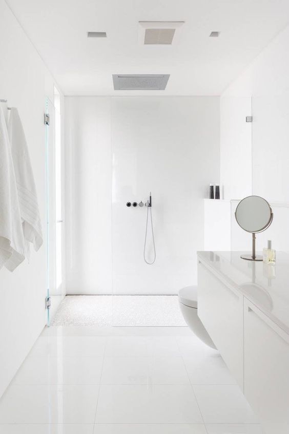 بالصور ديكورات حمامات انيقة باللون الابيض لمنزلك في ربيع 2020 حصري A-minimalist-white-bathroom-with-a-window-in-the-shower-space-simple-large-scale-tiles-and-a-floating-sleek-vanity