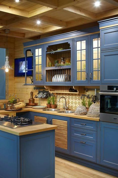 https://www.digsdigs.com/photos/2020/04/a-stylish-vintage-farmhouse-kitchen-with-blue-cabinets-and-buttercream-yellow-wooden-countertops-and-backsplashes.jpg