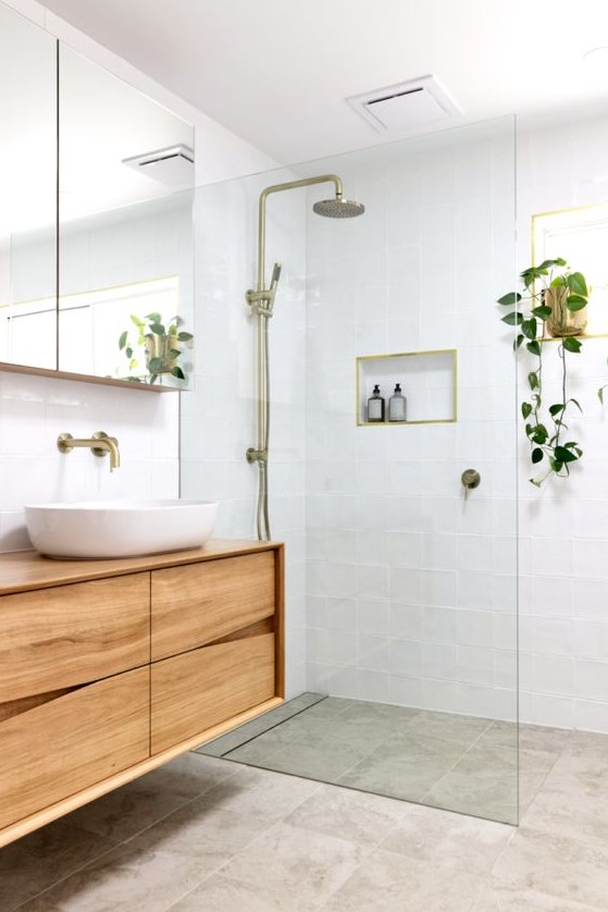 https://www.digsdigs.com/photos/2020/05/a-small-and-welcoming-modern-bathroom-with-white-and-grey-tiles-a-catchy-wooden-vanity-a-mirror-cabinet-and-touches-of-brass.jpg