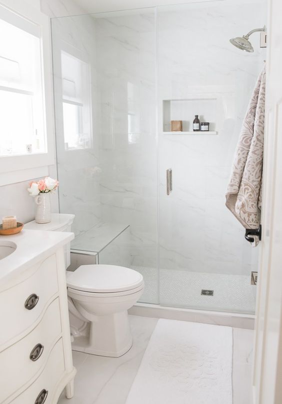 https://www.digsdigs.com/photos/2020/05/a-small-neutral-bathroom-with-white-marble-tiles-a-shower-space-a-white-vanity-some-neutral-textiles-is-cool.jpg