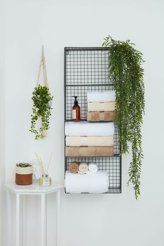 https://www.digsdigs.com/photos/2020/06/03-a-metal-wall-shelf-for-storing-towels-soaps-greenery-in-pots-is-a-nice-solution-to-save-some-floor-space.jpg