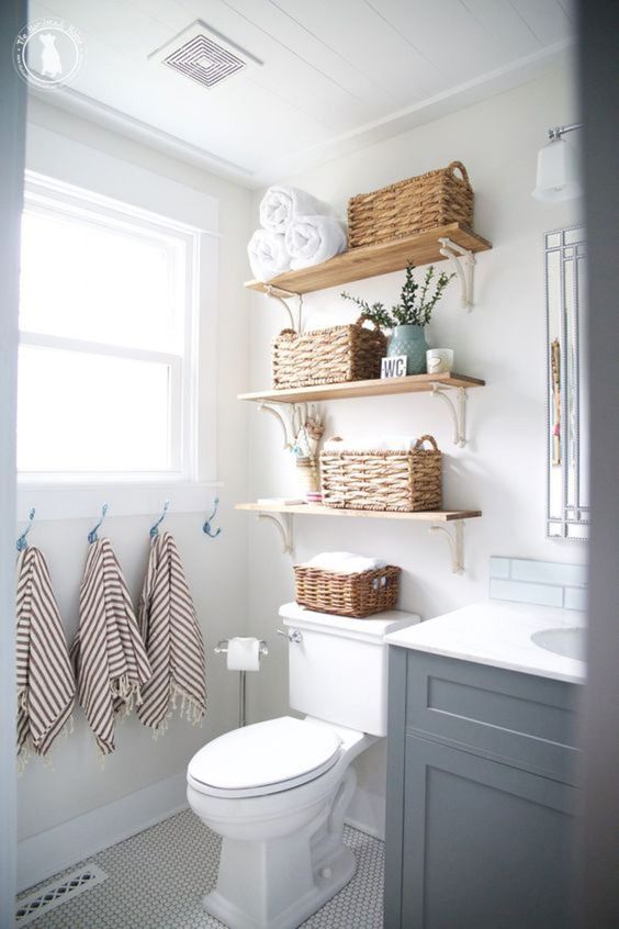 https://www.digsdigs.com/photos/2020/06/10-open-shelves-with-baskets-can-store-towels-comfortably-and-here-they-take-just-some-awkward-space-over-the-toilet.jpg