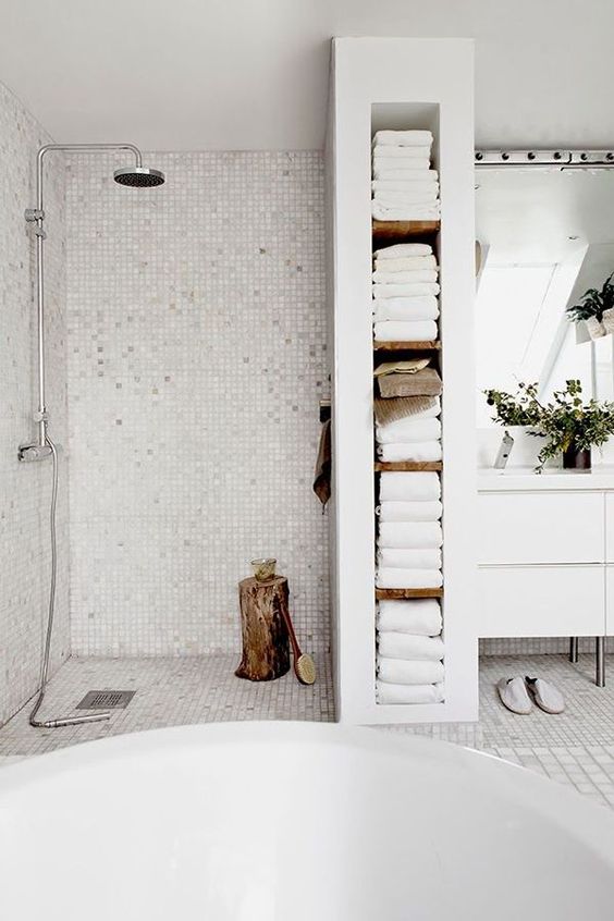 https://www.digsdigs.com/photos/2020/06/17-a-built-in-shelving-unit-that-doubles-as-a-shower-space-divider-and-holds-all-the-towels-is-a-smart-solution.jpg