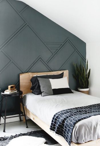 Picture Of a guest bedroom with a graphite grey paneled wall, a wooden ...