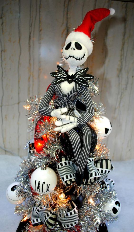 A silver lit up Nightmare Before Christmas tree with Jack ornaments and striped ribbons is a lovely and bold idea to rock.