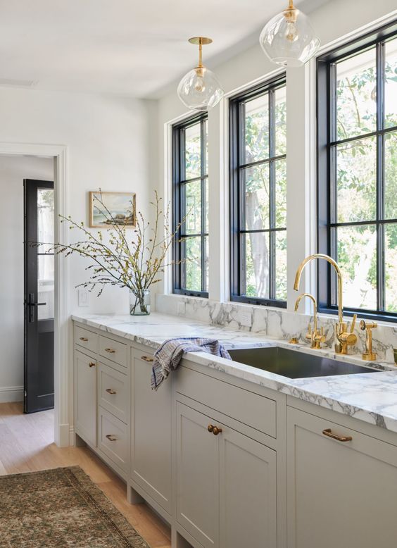 https://www.digsdigs.com/photos/2021/02/40-a-refined-greige-kitchen-with-a-white-marble-countertop-and-gold-fixtures-and-a-faucet-is-a-stylish-idea.jpg