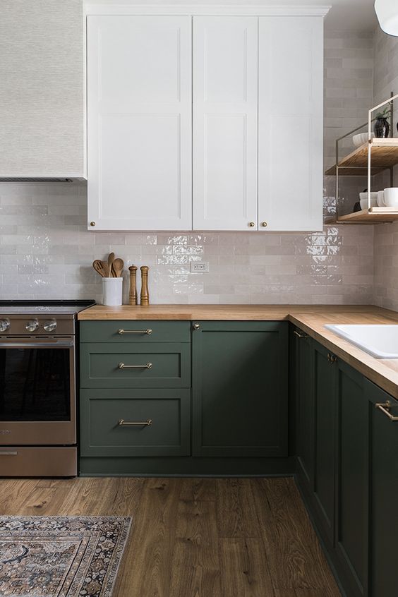 https://www.digsdigs.com/photos/2021/02/68-a-laconic-dark-green-and-white-kitchen-with-glossy-white-marble-tiles-a-butcherblock-countertop-and-simple-fixtures.jpg