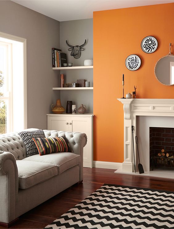 A Pretty Monochromatic Mid Century Modern Living Room Done In Grey Black And White And Cheered Up With A Bold Orange Accent Wall 