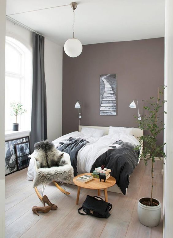 https://www.digsdigs.com/photos/2021/08/a-beautiful-boho-bedroom-with-a-taupe-accent-wall-a-creamy-upholstered-bed-and-lovely-bedding-a-round-table-and-a-chair-a-potted-plant.jpg