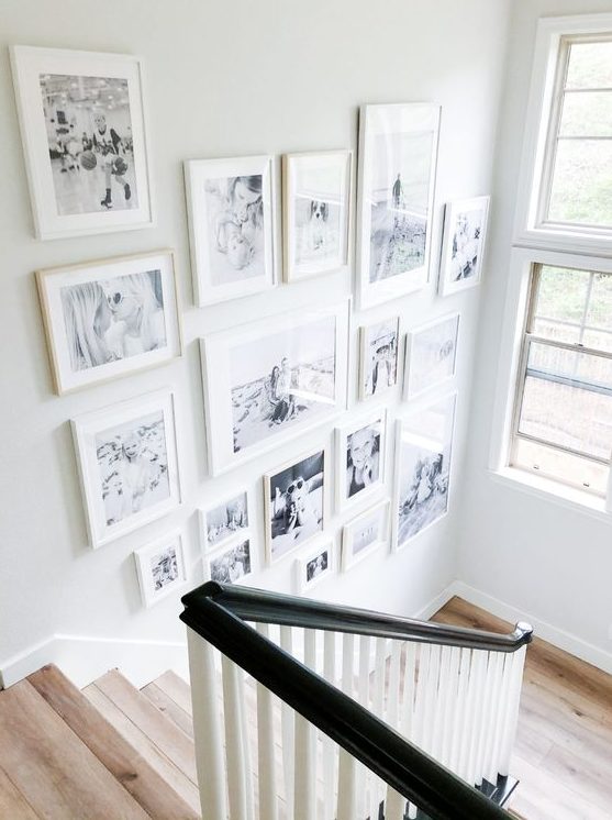https://www.digsdigs.com/photos/2021/11/a-beautiful-free-form-gallery-wall-with-white-mismatching-frames-is-a-cool-and-chic-idea-and-will-add-coziness.jpg