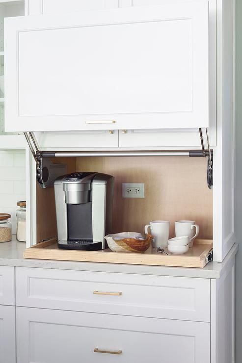 https://www.digsdigs.com/photos/2022/01/03-a-comfortable-coffee-station-with-a-raising-door-and-a-retractable-shelf-is-a-cool-idea-to-hide-the-bar-when-not-in-need.jpg