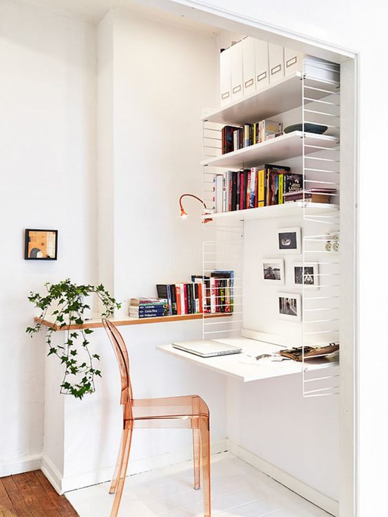 https://www.digsdigs.com/photos/2022/02/28-a-small-and-cool-nook-turned-into-a-home-office-with-a-large-shelving-unit-with-lots-of-books-a-desk-here-an-amber-acrylic-chair-and-greenery.jpg