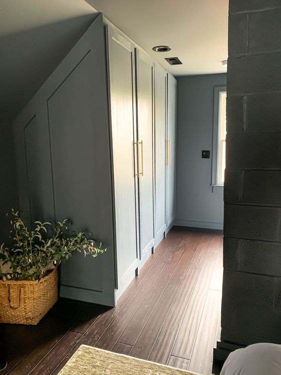 https://www.digsdigs.com/photos/2022/03/a-blue-walk-in-closet-with-attic-built-in-wardrobes-that-are-a-perfect-way-to-use-every-inch-of-space-available.jpg