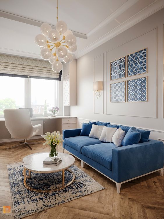 كنب عصري باللون الازرق A-pretty-dove-grey-and-blue-living-room-with-a-windowsill-desk-a-creamy-chair-a-blue-sofa-and-a-gallery-wall-of-blue-wallpaper-a-round-table