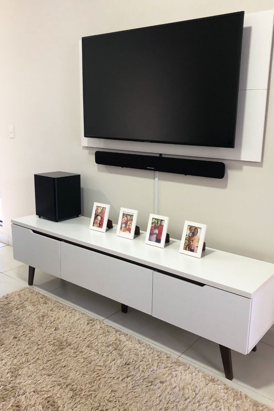 https://www.digsdigs.com/photos/2022/04/18-a-neutral-space-with-a-sleek-and-stylish-media-console-a-wall-mounted-TV-with-all-the-cords-hidden-away-in-a-tube-attached-to-the-wall.jpg