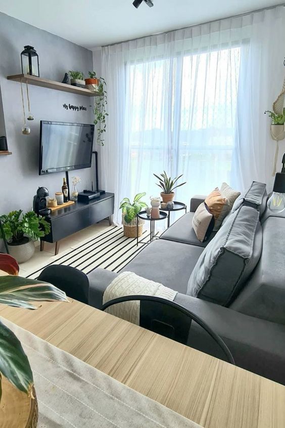 https://www.digsdigs.com/photos/2022/04/19-a-stylish-small-Scandi-living-room-with-a-wall-mounted-TV-and-all-the-wires-hidden-inside-black-wire-tubes-attached-to-the-wall.jpg