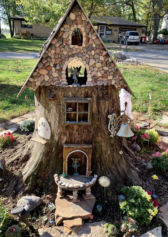 15 A Super Creative Garden Decoration Made Of A Tree Stump With A Pebble Roof And Some Little Elves With Blooms Around 