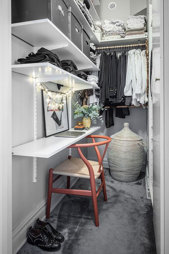 https://www.digsdigs.com/photos/2022/11/a-narrow-closet-done-with-open-shelves-railings-a-shelf-that-is-a-desk-a-chair-a-basket-with-a-lid-and-some-lights.jpg