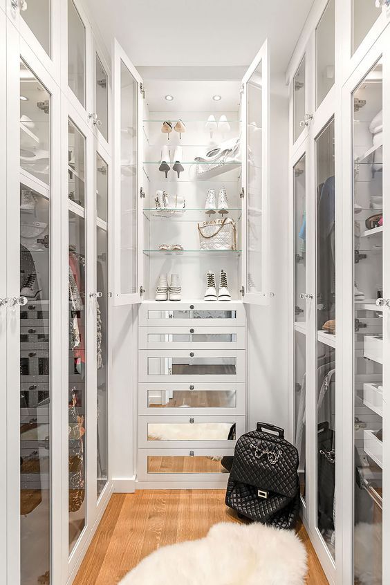https://www.digsdigs.com/photos/2022/11/a-narrow-walk-in-closet-with-glass-doors-with-open-cabinets-and-shelves-with-mirror-drawers-is-a-glam-and-refined-idea.jpg